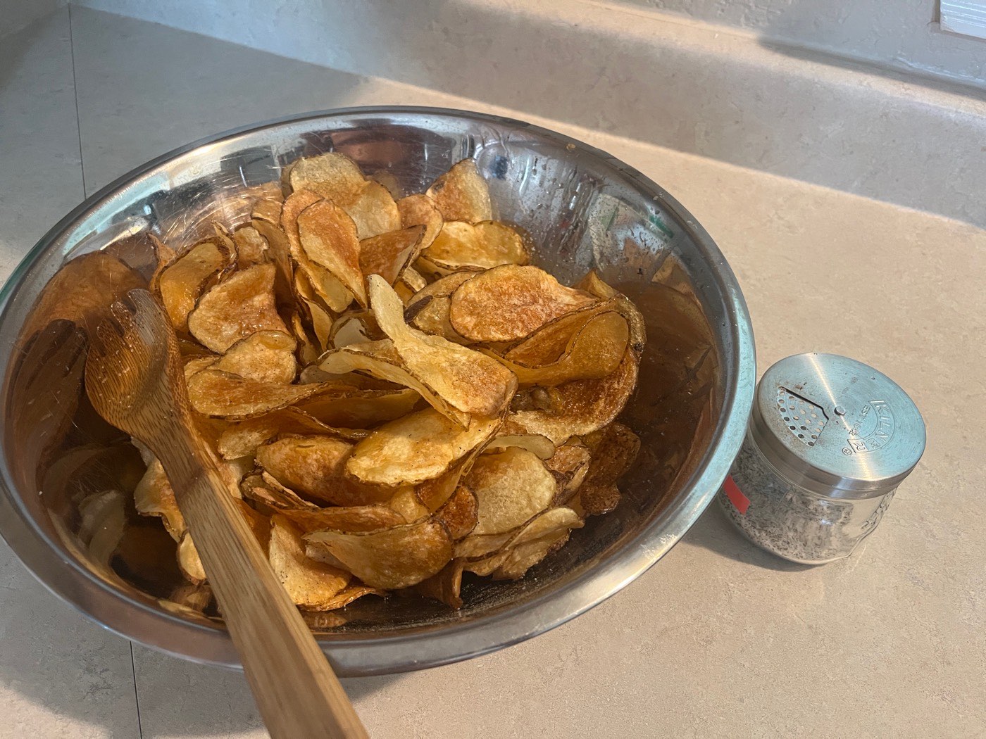 A bowl of golden homemade potato chips