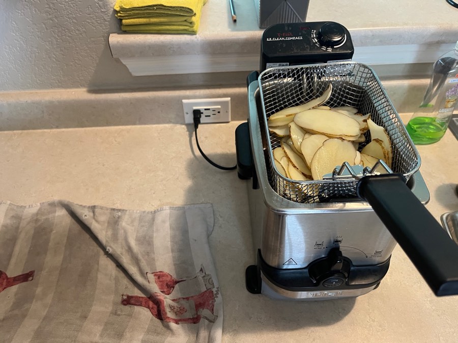 Put the chips in the basket first. Dropping them into the oil will splatter on you, which is unpleasant.
